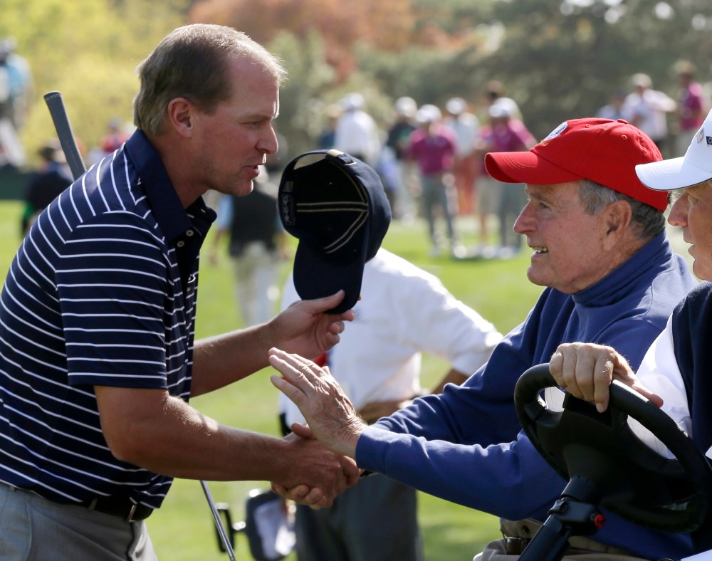 USA's Steve Stricker shakes hands with former President George H. W. Bush during a four-ball match at the Ryder Cup PGA golf tournament Saturday, Sept. 29, 2012, at the Medinah Country Club in Medinah, Ill.