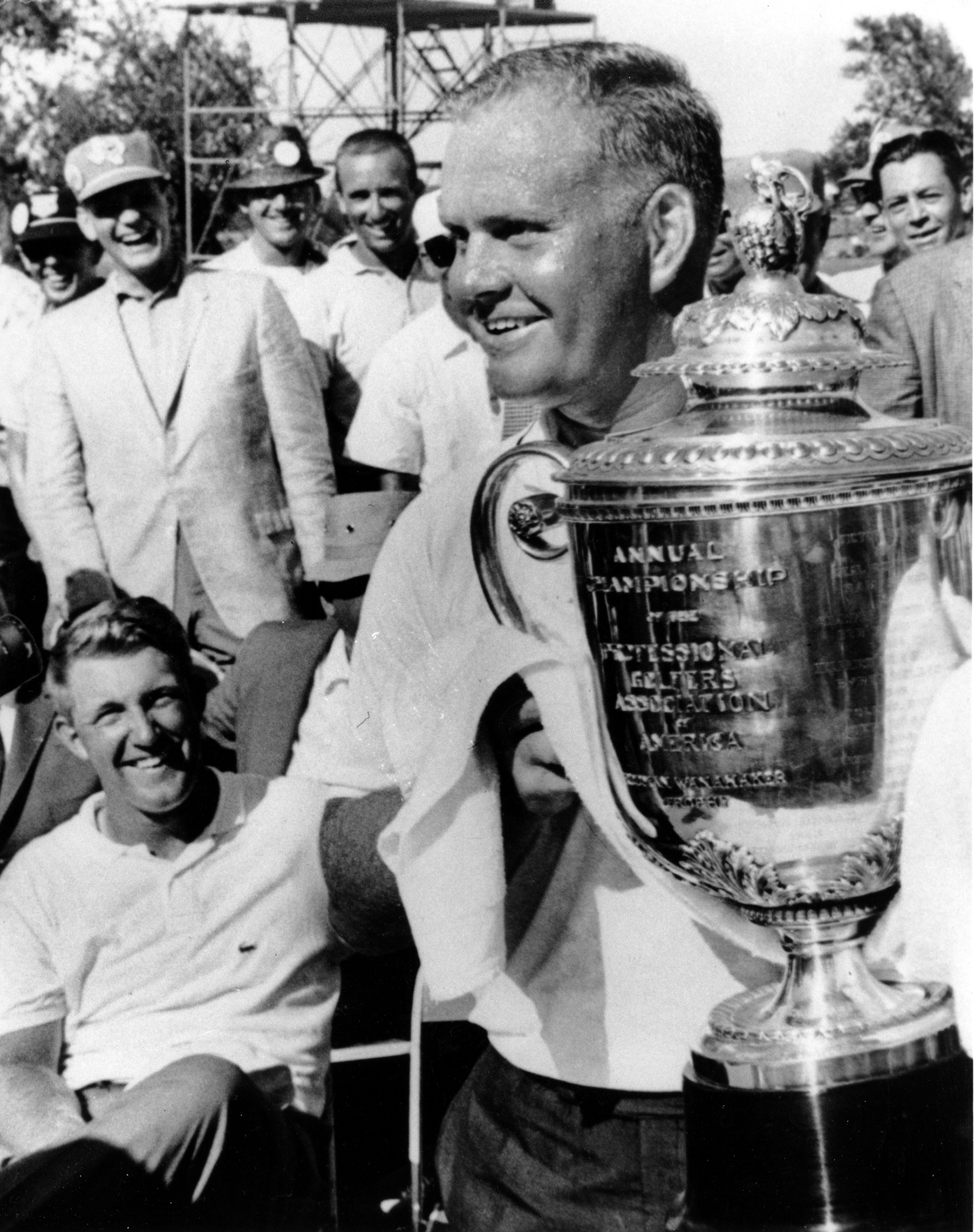 Golfer Jack Nicklaus holds up the Wanamaker trophy after winning the PGA championship in Dallas, Tex., on July 22, 1963. Seated left is Dave Ragan who was runner up.