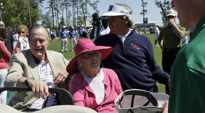Former President George H.W. Bush, left, and his wife Barbara, center, talk with professional golfer Fred Couples, right, during a visit to the Houston Open golf tournament on April 3, 2009 in Humble, Texas.