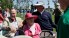 Former President George H.W. Bush, left, and his wife Barbara, center, talk with professional golfer Fred Couples, right, during a visit to the Houston Open golf tournament on April 3, 2009 in Humble, Texas.