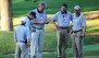 Rules officials congregate at Atlanta Athletic Club's 14th hole during the PGA Championship.