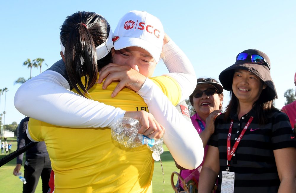 LOS ANGELES, CA - APRIL 22: Ariya Jutanugarn of Thailand hugs her sister Moriya Jutanugarn with family on the 18th green in celebration of Moriya's victory in the Hugel-JTBC LA Open at the Wilshire Country Club on April 22, 2018 in Los Angeles, California. (Photo by Harry How/Getty Images)