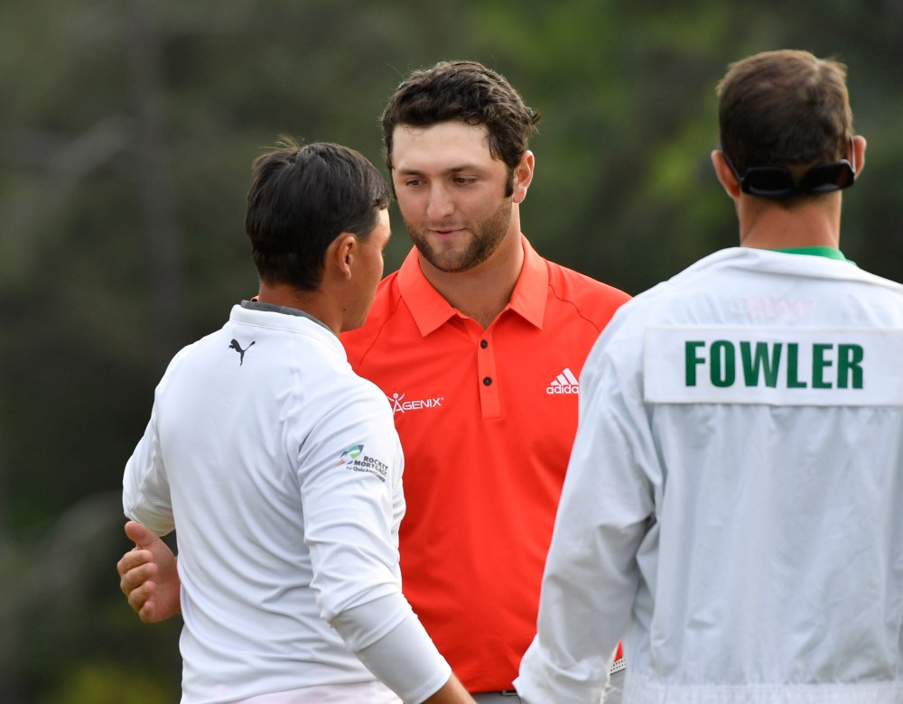 Apr 8, 2018; Augusta, GA, USA; Rickie Fowler (left) greets Jon Rahm on the 18th green during the final round of the Masters golf tournament at Augusta National Golf Club. Mandatory Credit: Michael Madrid-USA TODAY Sports