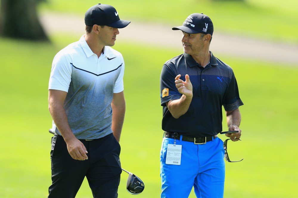 WESTBURY, NY - AUGUST 23:  Brooks Koepka of the USA walks with his coach Claude Harmon III during practice for The Northern Trust at Glen Oaks Club on August 23, 2017 in Westbury, New York.  (Photo by Andrew Redington/Getty Images)