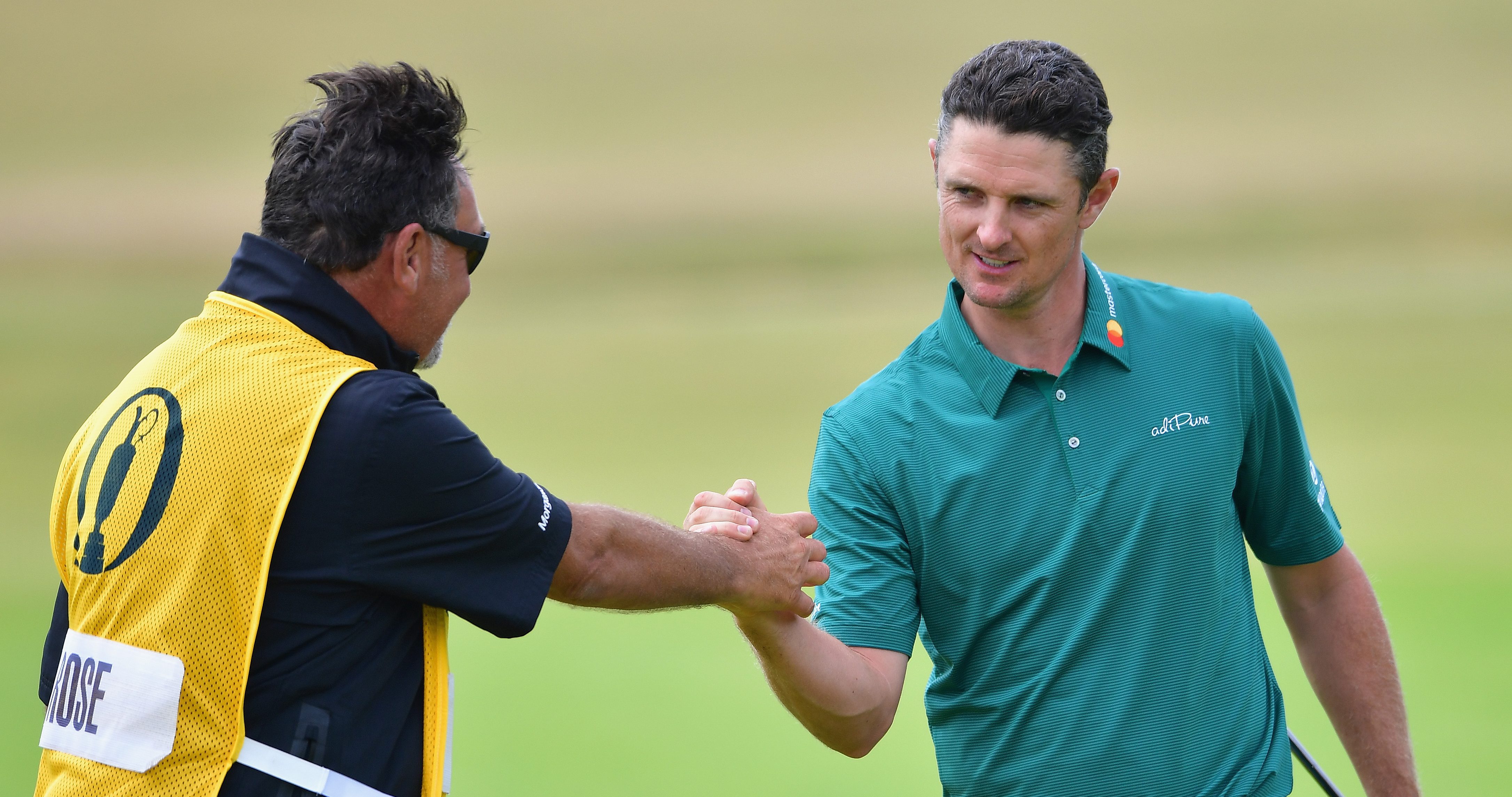 CARNOUSTIE, SCOTLAND - JULY 21: Justin Rose of England with his caddie Mark Fulcher on the 18th green during the third round of the 147th Open Championship at Carnoustie Golf Club on July 21, 2018 in Carnoustie, Scotland. (Photo by Stuart Franklin/Getty Images)