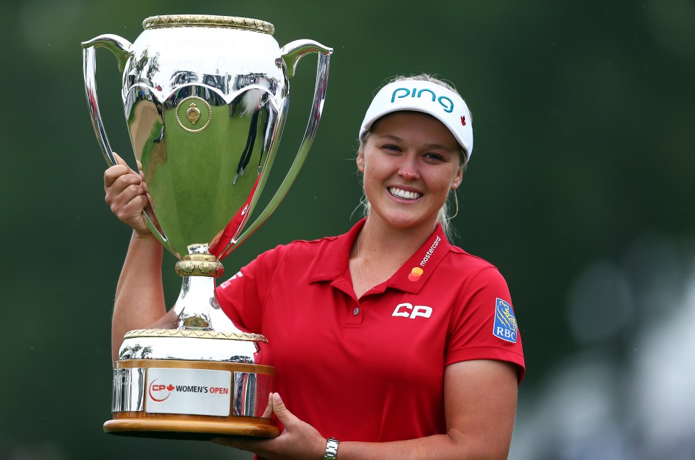 REGINA, CANADA - AUGUST 26: Brooke Henderson of Canada lifts the champions trophy following the final round of the CP Womens Open at the Wascana Country Club on August 26, 2018 in Regina, Canada. (Photo by Vaughn Ridley/Getty Images)