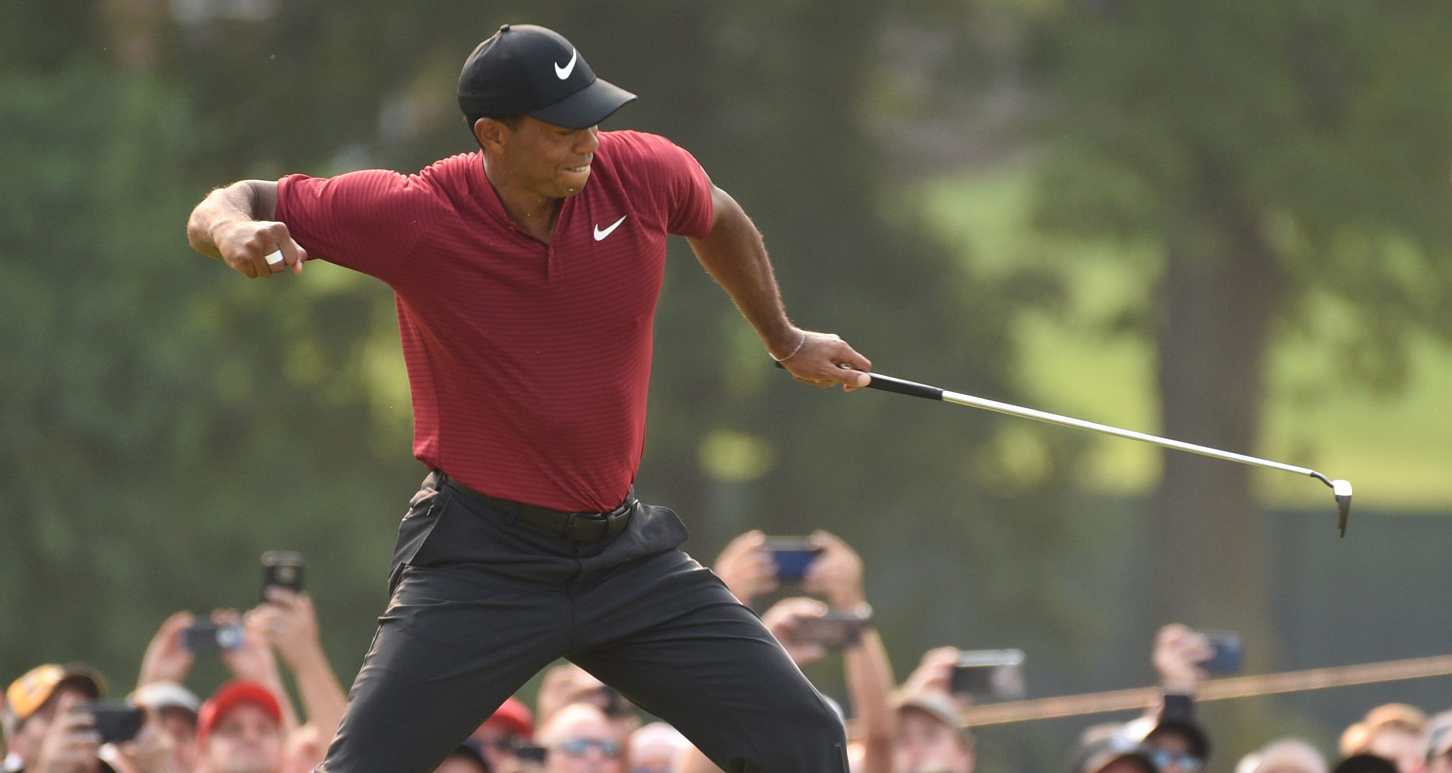Aug 12, 2018; Saint Louis, MO, USA; Tiger Woods celebrates after making a birdie putt on the 18th green during the final round of the PGA Championship golf tournament at Bellerive Country Club. Mandatory Credit: John David Mercer-USA TODAY Sports