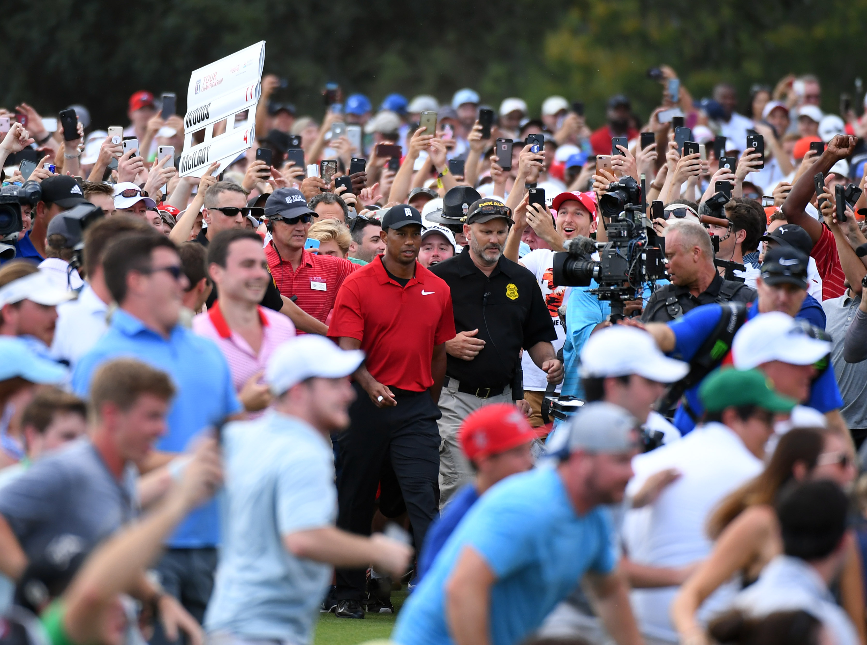 Sep 23, 2018; Atlanta, GA, USA; The crowd follows Tiger Woods down the 18th green during the final round of the Tour Championship golf tournament at East Lake Golf Club. Mandatory Credit: Christopher Hanewinckel-USA TODAY Sports