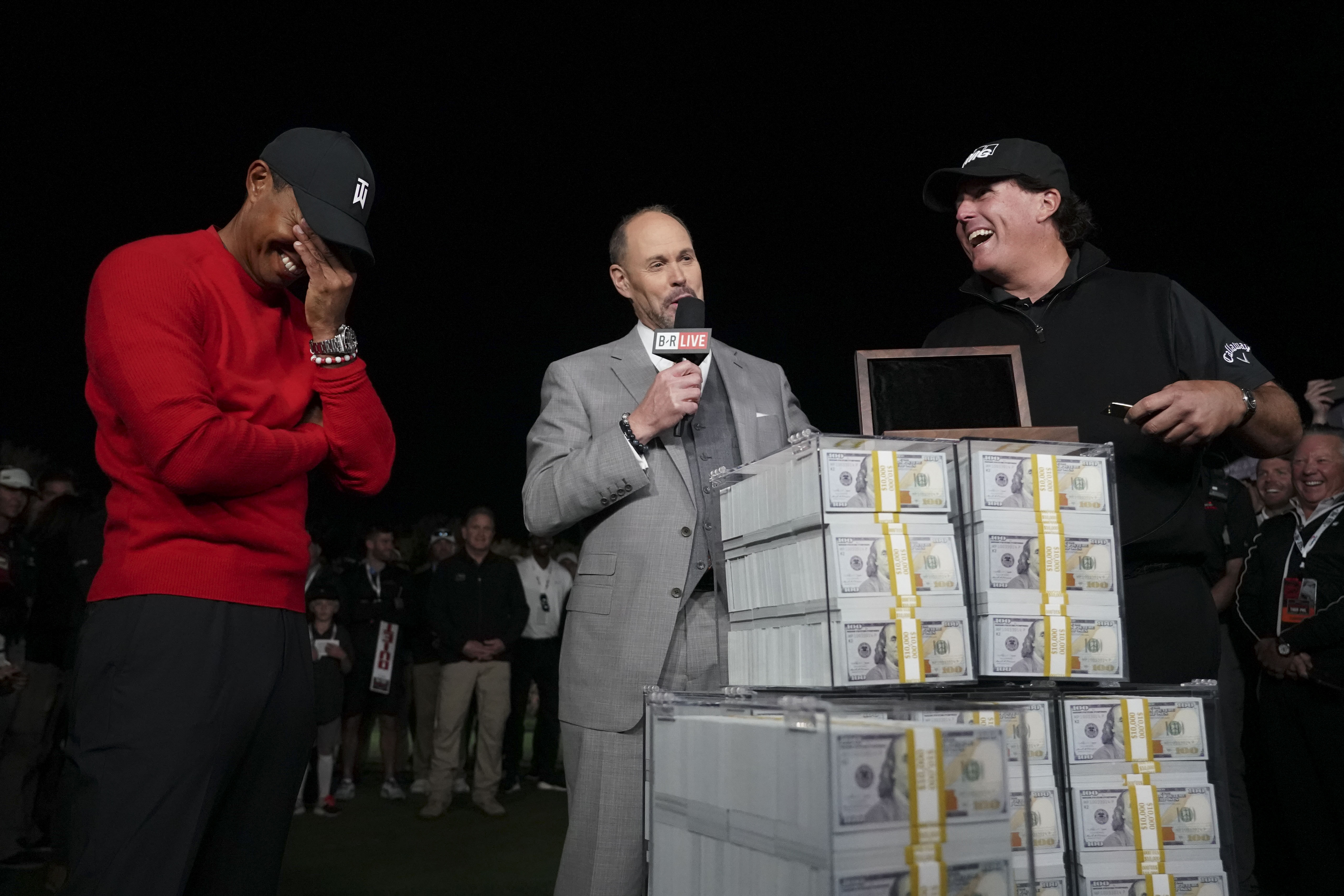 Nov 23, 2018; Las Vegas, NV, USA; Phil Mickelson (right) reacts after the winner's belt didn't fit as Tiger Woods (left) looks on after The Match: Tiger vs Phil golf match at Shadow Creek Golf Course. Mandatory Credit: Rob Schumacher-USA TODAY Sports
