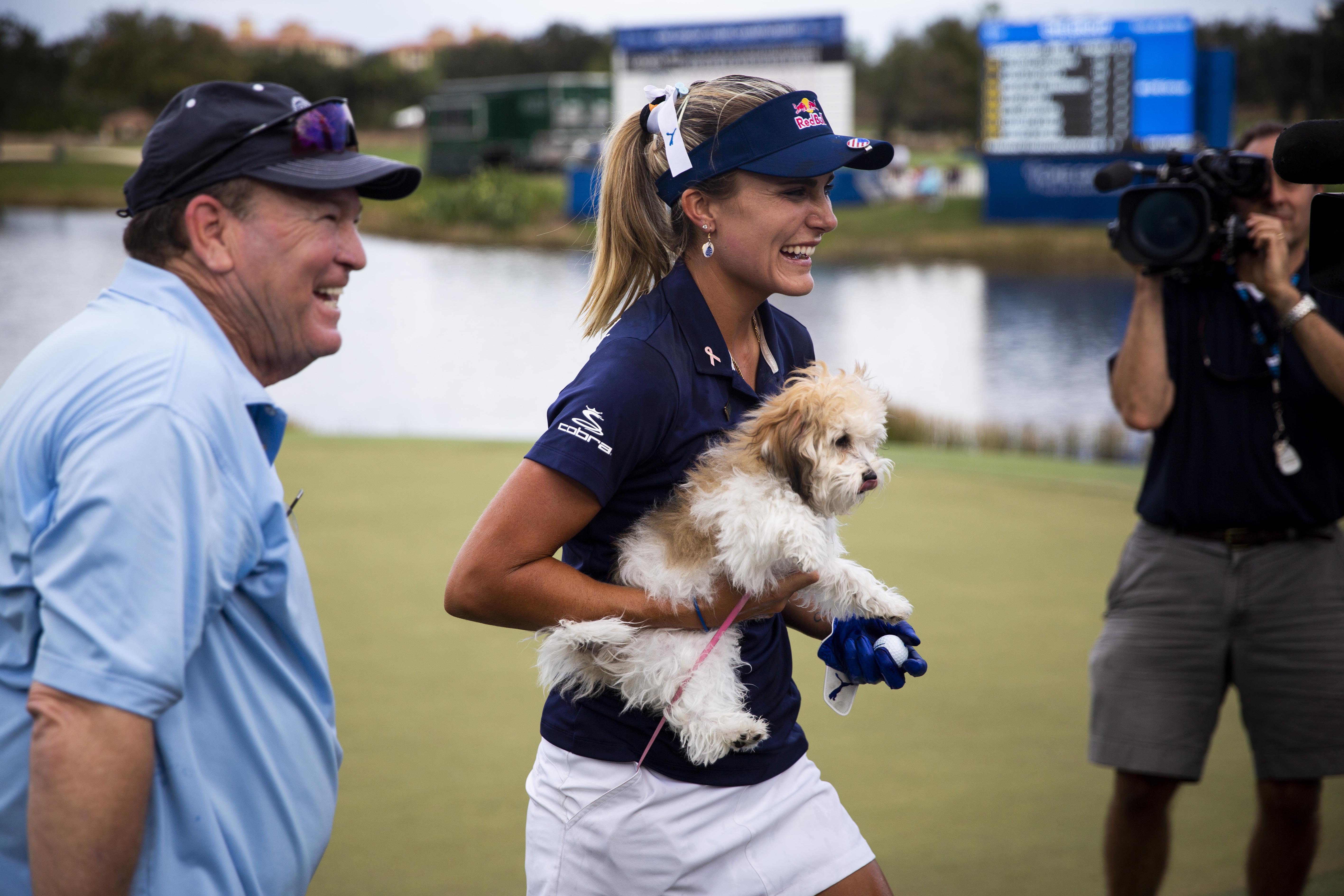 November 18, 2018; Naples, FL, USA; Lexi Thompson carries her dog Leo after winning the CME Group Tour Championship, the final event of the LPGA Tour, on Sunday, November 18, 2018, at Tiburon Golf Club in Naples. Mandatory Credit: Alex Driehaus/Naples Daily News via USA TODAY NETWORK