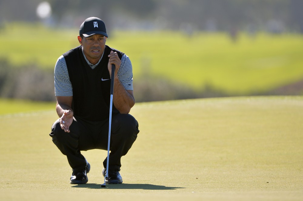 Jan 25, 2019; San Diego, CA, USA; Tiger Woods lines up a putt on the 13th green during the second round of the Farmers Insurance Open golf tournament at Torrey Pines Municipal Golf Course - South Course. Mandatory Credit: Orlando Ramirez-USA TODAY Sports