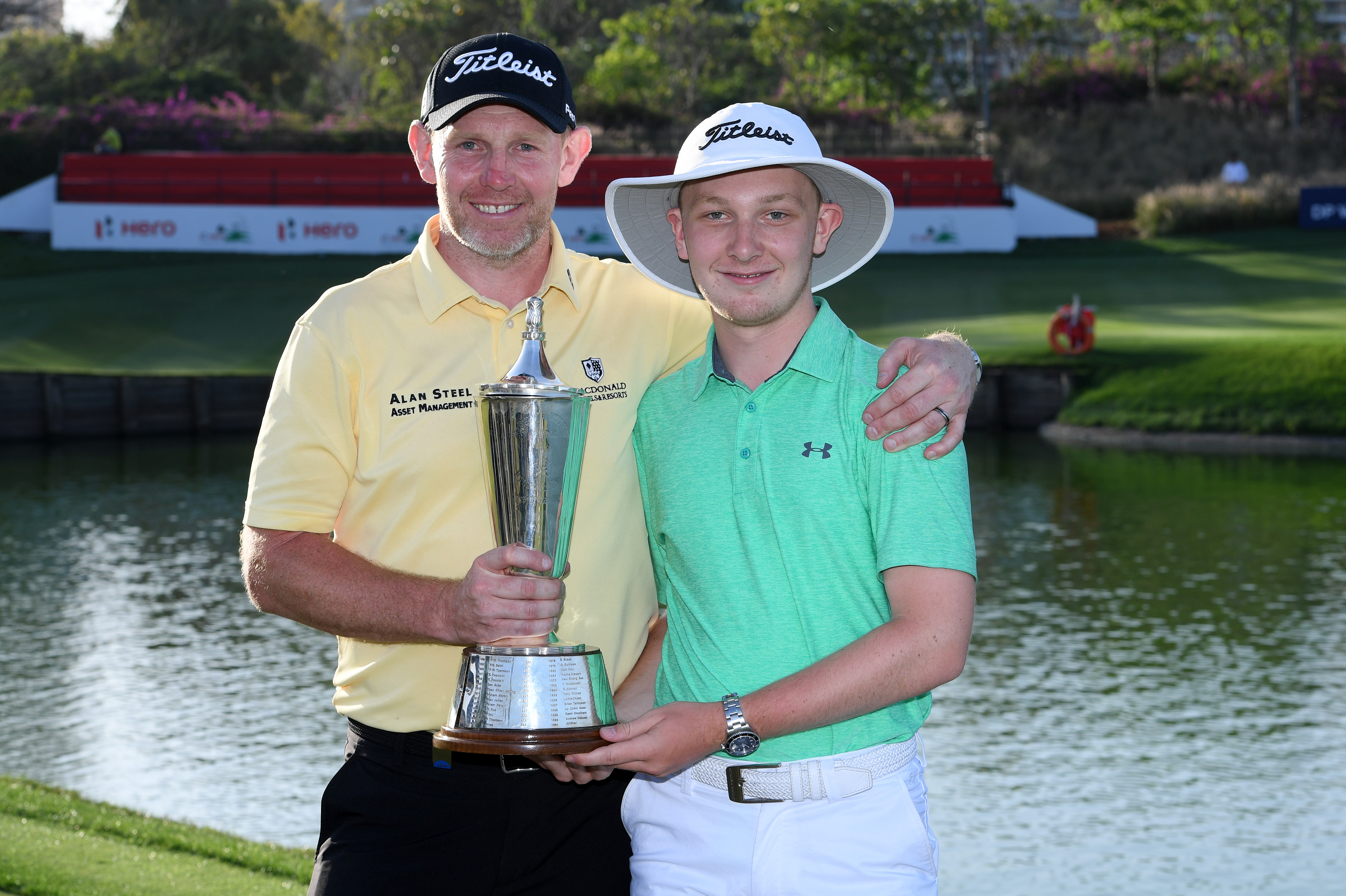 NEW DELHI, INDIA - MARCH 31: Stephen Gallacher of Scotland poses with his Son and the trophy after he wins the final round on day four of the Hero Indian Open at the DLF Golf & Country Club on March 31, 2019 in New Delhi, India. (Photo by Ross Kinnaird/Getty Images)