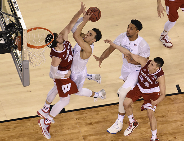 Duke Blue Devils guard Tyus Jones (5) shoots the ball against Wisconsin Badgers forward Frank Kaminsky (44) during the second half in the 2015 NCAA Men's Division I Championship game at Lucas Oil Stadium. (USA TODAY Sports)