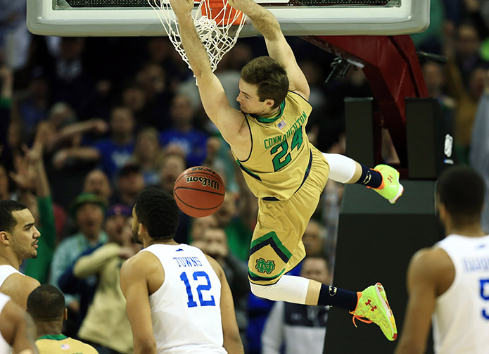 Notre Dame Fighting Irish guard/forward Pat Connaughton (24) dunks ahead of Kentucky Wildcats forward Karl-Anthony Towns (12) during the second half in the finals of the midwest regional of the 2015 NCAA Tournament at Quicken Loans Arena. (USA TODAY Sports)