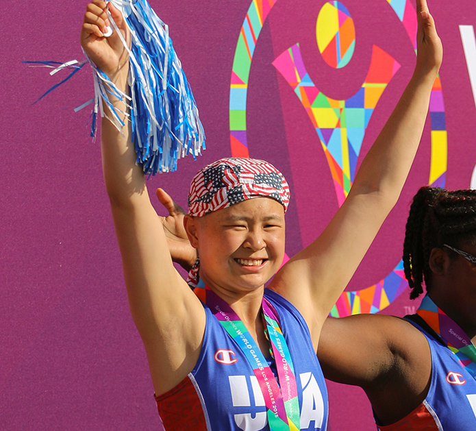 Olivia strikes the signature Special Olympics pose. (Aaron Mills/Special Olympics USA)