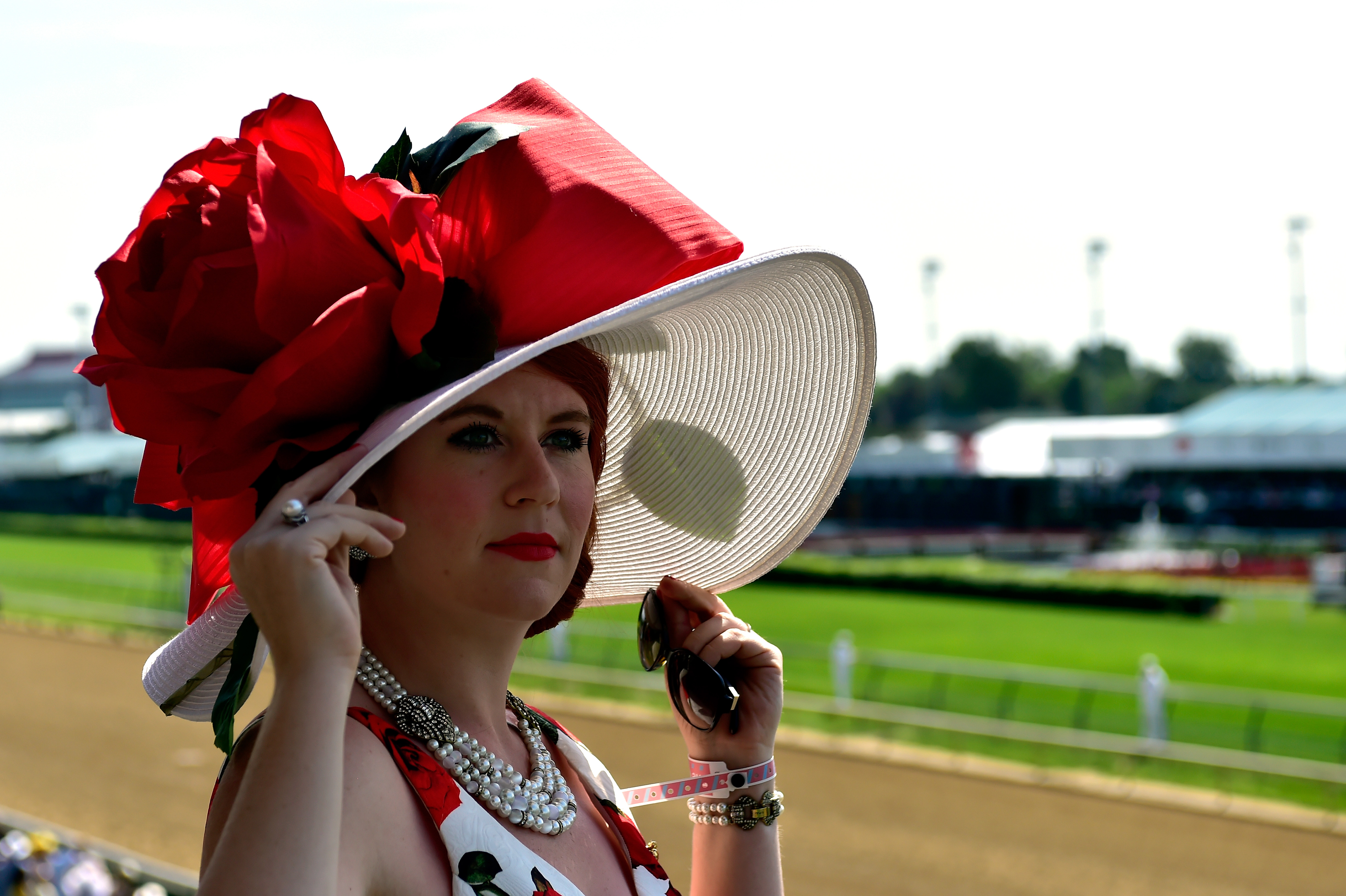 LOUISVILLE, KY - MAY 07: A woman wearing a festive hat looks on prior to the 142nd running of the Kentucky Derby at Churchill Downs on May 07, 2016 in Louisville, Kentucky. (Photo by Logan Riely/Getty Images) ORG XMIT: 614259857 ORIG FILE ID: 528927104
