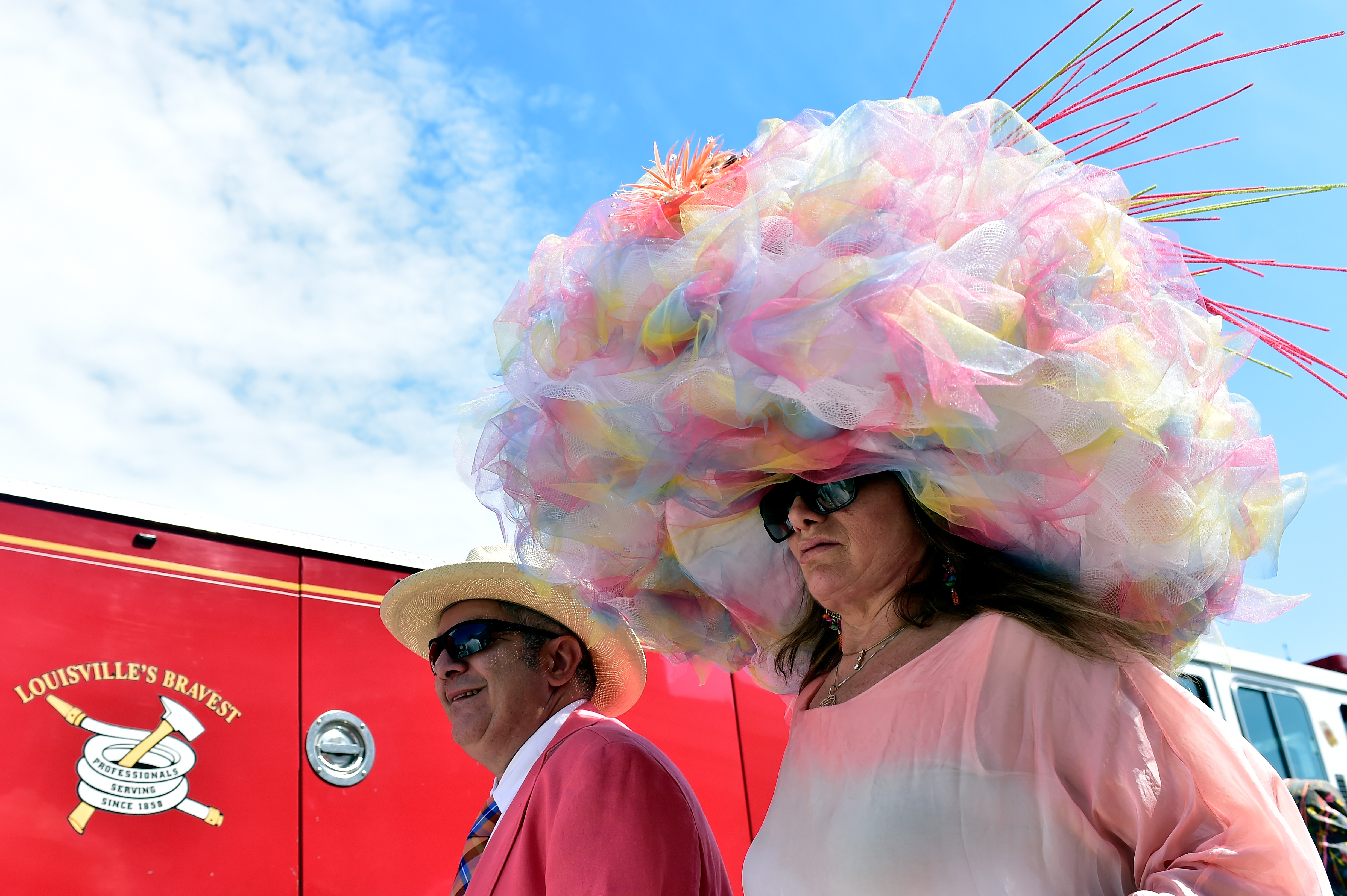 LOUISVILLE, KY - MAY 07: A man and woman wearing festive hats walk the grounds prior to the 142nd running of the Kentucky Derby at Churchill Downs on May 07, 2016 in Louisville, Kentucky. (Photo by Logan Riely/Getty Images) ORG XMIT: 614259857 ORIG FILE ID: 528932846