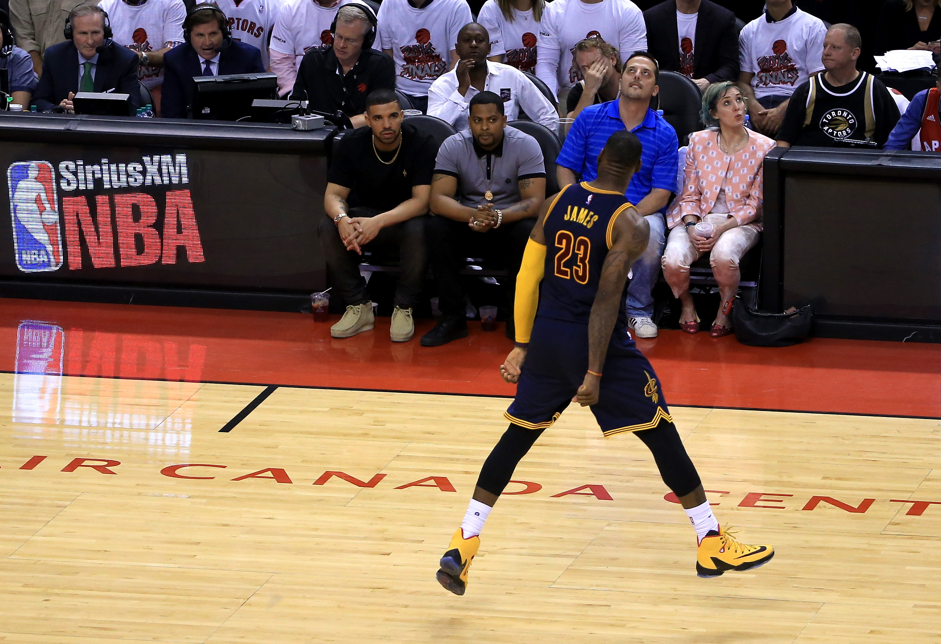 TORONTO, ON - MAY 23: LeBron James #23 of the Cleveland Cavaliers reacts in front of rapper Drake in the fourth quarter against the Toronto Raptors in game four of the Eastern Conference Finals during the 2016 NBA Playoffs at the Air Canada Centre on May 23, 2016 in Toronto, Ontario, Canada. NOTE TO USER: User expressly acknowledges and agrees that, by downloading and or using this photograph, User is consenting to the terms and conditions of the Getty Images License Agreement. (Photo by Vaughn Ridley/Getty Images) ORG XMIT: 640105487 ORIG FILE ID: 533869540