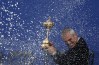 TOPSHOTS Captain of Team Europe Paul McGinley of Ireland is sprayed with champagne as he holds the Ryder Cup trophy on the final day of the Ryder Cup golf tournament at the Gleneagles Hotel in Gleneagles, Scotland, on September 28, 2014. Jamie Donaldson grabbed the crucial point Paul McGinley's side needed for the win when he defeated Keegan Bradley 4 and 3 in the 10th of the closing 12 singles. AFP PHOTO/ADRIAN DENNISADRIAN DENNIS/AFP/Getty Images ORG XMIT: 4585 ORIG FILE ID: 533899998